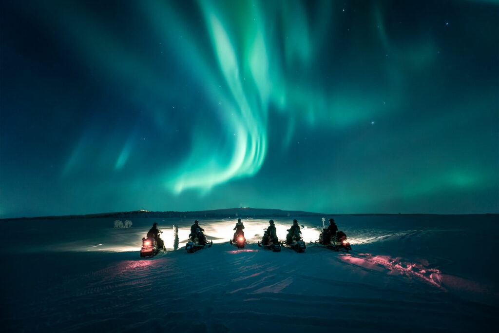 Group Searching for the Auroras by snowmobile safari from Levi eng